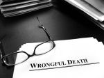 Wrongful Death Lawsuit Papers on Desk for Lawsuit with Glasses